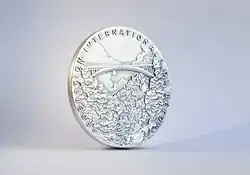 Photo shows a photograph of the "fib Medal of Merit" of the Fédération internationale du béton