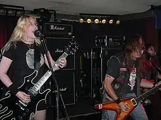 Fireball Ministry in 2004. L–R: Guitarist Emily Burton, vocalist/guitarist James A. Rota II, and bassist Janis Tanaka