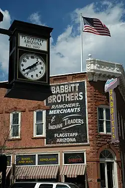 Commercial building with clock in foreground