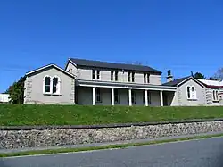 A two storey courthouse building with two one-storey wings