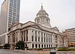 Angle view of large white limestone building with tall rotunda