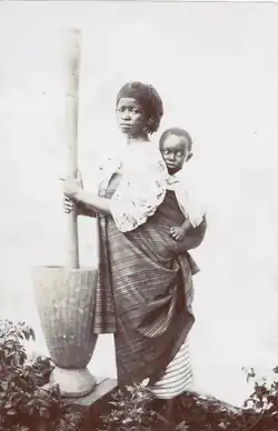 c. 1894-1896 Cabinet card showing a woman from Senegal working while carrying a child.