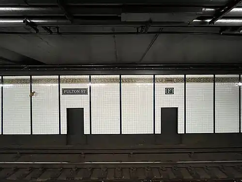 Full-name and "F" mosaics below trim line