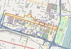 In the middle of a colored road map, a long strip of land is outlined in orange, while a small rectangle within this strip is outlined in red.