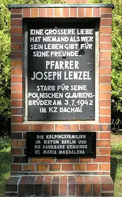 Commemorative plaque in front of St Mary Magdalene's parish on 22 Platanenstraße street in Berlinie-Niederschönhausen, in memorial of priest Josef Lenzel, that gave his life for Poles – brothers in faith