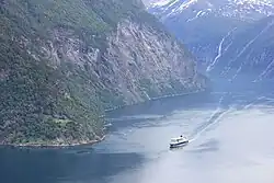 The coastal express passes the old fjord farm Lundaneset