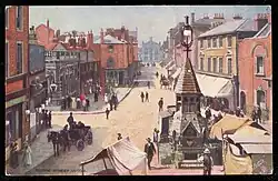 A postcard showing a streetscene of George Street, Luton looking North West towards the town hall in the early 20th Century.