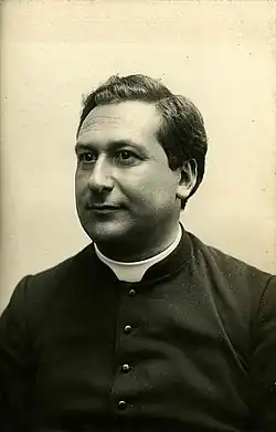 A middle-aged man in a Catholic cassock
