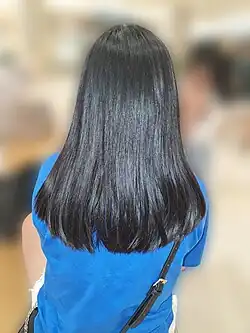 An Indonesian adolescent girl with armpit length hair