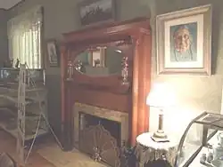 Fireplace in the living room of the Manistee Mansion .