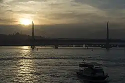 Golden Horn Metro Bridge from Galata Bridge in sunset.