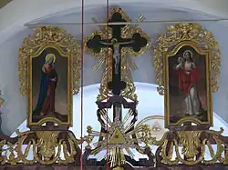 The three icons on the top of the iconostasis