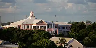 A large pink-tinged building set among trees