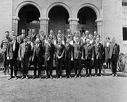 Black and white group portrait of men and women standing