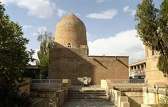 Large brick building with a rounded column