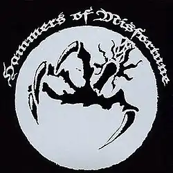 A large outstretched talon in a silver circle. The text "Hammers of Misfortune" is displayed above it.