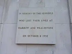 The disaster memorial stone plaque on display at the north entrance of Harrow and Wealdstone railway station