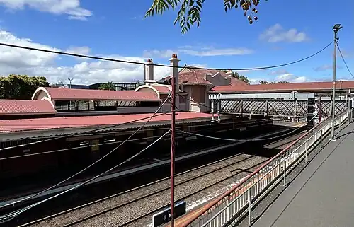 South-east view of the station, Platform 1, footbridge and Edwardian building