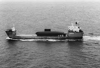 A Chinese Kilo-class submarine being delivered from Russia as deck cargo in 1995.
