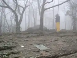A hiker signs the register on Springer Mountain, GA, southern terminus of the trail.