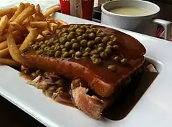 Quebec-style "hot chicken", topped with green peas