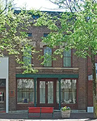 Brick three-story building sharing walls with buildings on both sides