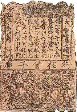 A brown piece of paper, about one and a half times as long as it is wide, divided into two sections. The larger top section contains a large block of text, framed by a thick border that itself contains text. The smaller bottom section contains a line drawing, heavily distorted by age, possibly of a garden.