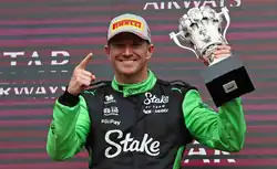 Hülkenberg holding his trophy on the podium of the 2025 British Grand Prix