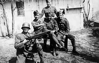 Hungarian soldiers in the Carpathians in 1944 (one wearing a helmet and the rest wearing forage caps)