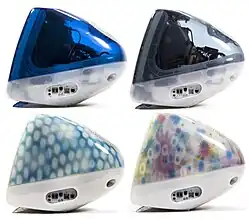 Side view of four iMacs, in clear dark blue, gray, blue with light circle spots, and multicolored flowers screened on its surface.