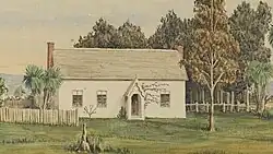 A drawing of a white schoolhouse in a grassy environment with trees surrounding it