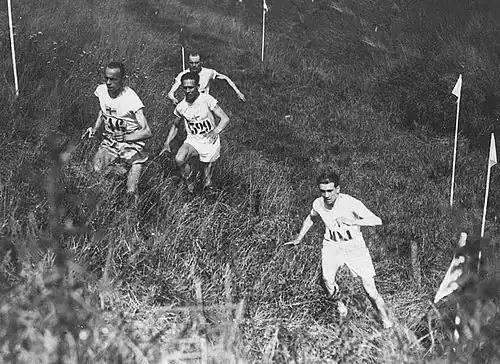 Image 24Edvin Wide, Ville Ritola, and Paavo Nurmi (on left) competing in the individual cross country race at the 1924 Summer Olympics in Paris; due to the hot weather, which exceeded 40 °C (104 °F), only 15 out of 38 competitors finished the race. (from Cross country running)