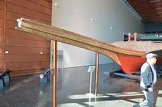 The bow is decorated with symbols such as star, crescent, sun, stylized leaves, and flowers