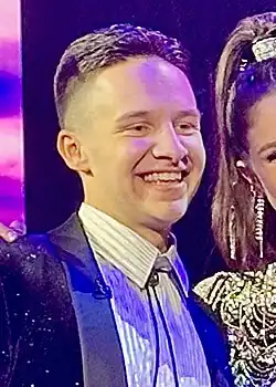 Blocker poses for pictures during a commercial break on American Idol in May 2024.