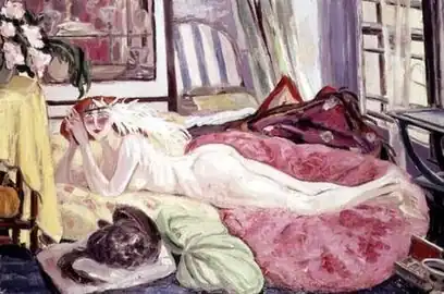 Image of the artist Jacqueline Marval's painting "The Bohemian" from 1921. A nude woman with long white feathers attached to a headband lays on pillows or blankets in a cluttered salon next to a black cat in the foreground on a pink pillow.