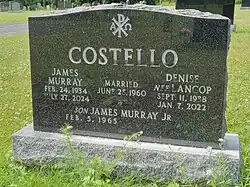 Black granite stone engraved with names of Costello and his wife