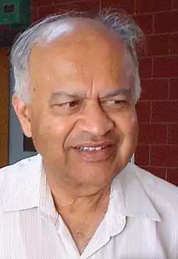 Close up of a smiling bald man.