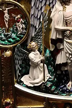 Angel kneeling beside Christ, holding the Spear of Longinus