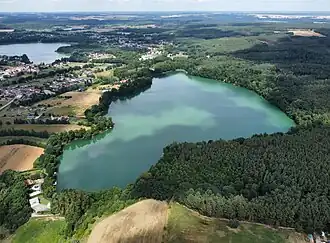A body of water encircled by trees.