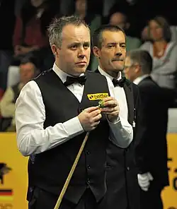 John Higgins playing a shot