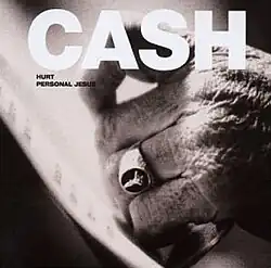 A closeup of an older male's hand. The hand is wearing a ring. "CASH" is embolded at the top in white, with "Hurt" and "Personal Jesus" below it in black.