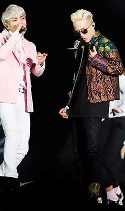 Jonghyun (left) and Zion.T (right) perform on stage together.