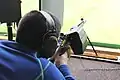 A junior shooter in Switzerland target shoots with a SIG 550. A brass catcher is fitted to avoid disturbing other shooters with the ejection.