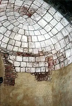 One of several preserved small late antique apses on the ground floor of the decagon with bricked-up windows. The limestone was once covered with mosaics.