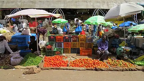 Tomato seller in the open-air section