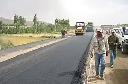 A smooth tarmac road with a roller engine in action