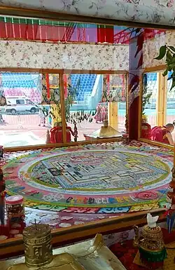 Kalachakra mandala in a special glass pavilion. Buddhist pilgrims bypass the pavilion in a clockwise direction three times. Buryatiya, July 16, 2019