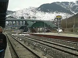 Station with overhead walkway and mountains in the background