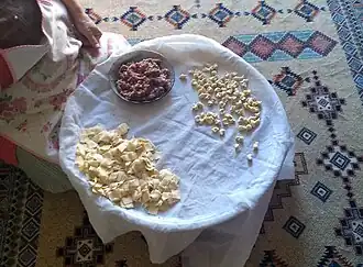 Turkish woman preparing Kayseri mantısı on a tray