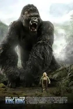 In a jungle landscape, a woman stands in front of a giant ape-like creature.
